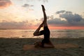 woman doing yoga shoulderstand on beach Royalty Free Stock Photo