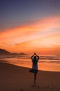 Woman doing yoga at sunrise in the beach of Ubatuba, Sao Paulo, Brazil Royalty Free Stock Photo