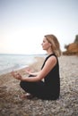 Woman doing yoga at sunset on the beach Royalty Free Stock Photo