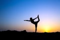 Woman doing yoga sunset silhouette