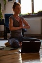 woman doing yoga workout at home watching videos online on laptop computer Royalty Free Stock Photo