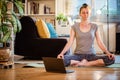 woman doing yoga workout at home watching videos online on laptop computer Royalty Free Stock Photo