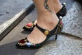 Woman with Dolce and Gabbana shoes with heart and arrow before Dolce and Gabbana fashion show, Milan Fashion