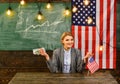 Woman with dollar money for bribe. American education reform at school in july 4th. Income planning of budget increase Royalty Free Stock Photo