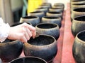 Woman donating money into Buddhist monk alms bowl for making merit Royalty Free Stock Photo