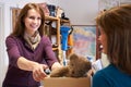 Woman Donating Unwanted Items To Charity Shop Royalty Free Stock Photo