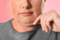 Woman with double chin on pink, closeup