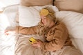 Woman dozing off with phone in hand