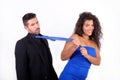 Woman dragging a man with his tie Royalty Free Stock Photo