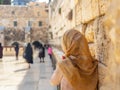 Contemplative Woman by Historic Wall