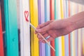 Woman draw heart on colorful fence with painting brush Royalty Free Stock Photo