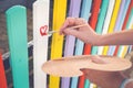 Woman draw heart on colorful fence with painting brush Royalty Free Stock Photo