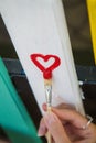 Woman draw heart on colorful fence with painting brush Royalty Free Stock Photo