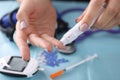 Woman drawing blood with lancet at home closeup