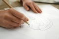 Woman drawing girl`s portrait with pencil on sheet of paper at table Royalty Free Stock Photo