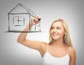 Woman drawing house on virtual screen Royalty Free Stock Photo