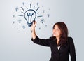 Woman drawing light bulb on whiteboard Royalty Free Stock Photo