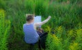 Woman drawing painting in nature