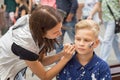 Woman drawing russian flag on the cheek of the young boy sport fan Royalty Free Stock Photo