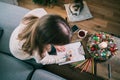 Woman drawing work-life balance wheel sitting on the sofa at home. Self-reflection and life planning for next new year