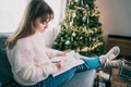 Woman drawing work-life balance wheel sitting on the sofa at home. Self-reflection and life planning for next new year