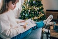 Woman drawing work-life balance wheel sitting on the sofa at home. Self-reflection and life planning for next new year