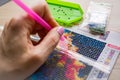 A woman draws a picture with beads. A set of images made of beads, handicrafts