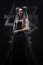 Woman with dreads and festive black gothic dress