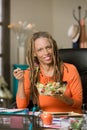 Woman with Drealocks Eating a Healthy Lunch at her Desk Royalty Free Stock Photo