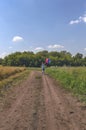 Woman in dress on bicycle with colorful balloons