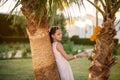 Beautiful girl at sunset in flowers. Royalty Free Stock Photo