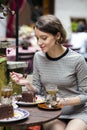 Woman at dress at cafe taste the cake