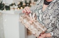 Woman in dress coloring Python holding a Christmas gift. Light background Royalty Free Stock Photo