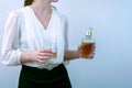 woman in a dress with a glass in one hand and a bottle of whiskey in the other hand. female alcoholism Royalty Free Stock Photo