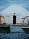 A woman in a dress near the traditional Mongolian dwelling yurt Royalty Free Stock Photo