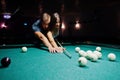 Woman in dress playing pool with a man in a pub Royalty Free Stock Photo