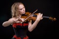 Woman in dress playing the violin Royalty Free Stock Photo