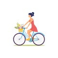 Woman in dress rides bicycle with basket of flowers