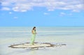 Woman in dress on a sandbank in the ocean. Royalty Free Stock Photo