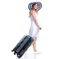 Woman in dress and summer hat, travel suitcase, luggage smiling happiness walking goes Royalty Free Stock Photo