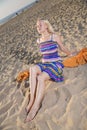 Woman in dress take sunbath on beach Royalty Free Stock Photo