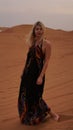 Woman in dress, view of desert sand. Landscape vertical photo Royalty Free Stock Photo