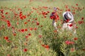 Woman at dress walk in poppy field