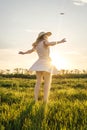 Woman in dress is spinning in the field Royalty Free Stock Photo