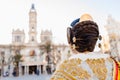 Woman dressed as a Fallera with her back turned, observes the facade of the Valencia City Hall, out of focus in the background Royalty Free Stock Photo