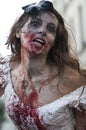 Woman dressed as a zombie parades on a street during a zombie walk in Paris.