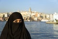 Woman dressed with black headscarf, chador on istanbul street, turkey