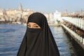 Woman dressed with black headscarf, chador on istanbul street, turkey