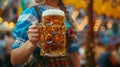 A woman dressed in a dirndl dress holds a stein of ambercolored nonalcoholic beer with a colorful banner reading Prost