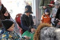 Woman dressed like XIX century teaching children how to play cards